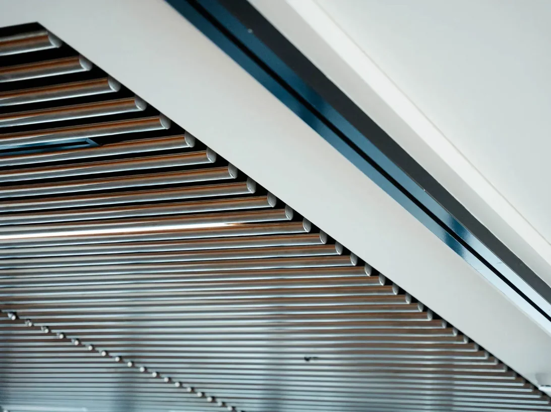 A suspended timber-batten ceiling running the length of an open floor